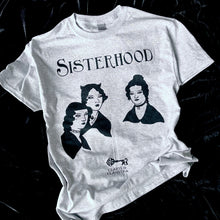 Load image into Gallery viewer, Photo of a grey marl t-shirt with the Bronte sisters iconic portrait except they have had a Goth makeover - they all have black hair, make up and piercings. Above is the caption &quot;Sisterhood&quot;. 