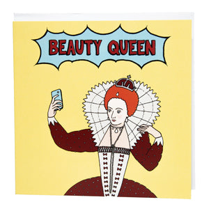 Photo of a large square yellow greetings card featuring a comic book style illustration of Queen Elizabeth I taking a selfie, with 'Beauty Queen' written in a flash above her. 