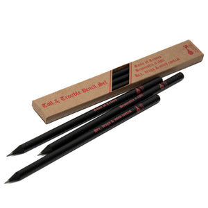 Set of three graphite pencils painted black with black wood, featuring slogans "Game of Crones", "Broomstix n chill" and "Hex, drugs & mind control". They are presented in a kraft brown box with red foiled lettering.