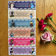 Load image into Gallery viewer, Set of bookmarks in neutrals, pinks and purples, with quotes and illustrations, laid on a wooden surface with flowers. Each bookmark features a different quote from one of Elizabeth Gaskell’s written works, accompanied by cartoon illustrations depicting Victorian characters with a modern twist.