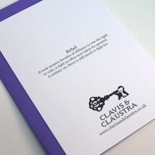 Load image into Gallery viewer, Photo of the back of the greetings card with the Clavis &amp; Claustra key logo and text headed “Rebel” in bold which reads: “It took women decades of defiance to win the right to vote, a right so often now taken for granted. A century on, there is still much to fight for.”