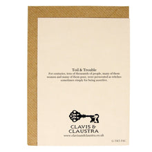 Load image into Gallery viewer, Photograph of the back of a white card on a brown envelope. The card features the Clavis &amp; Claustra key logo and above it the range name “Toil &amp; Trouble” and the caption “For centuries, tens of thousands of people, many of them women and many of them poor, were persecuted as witches sometimes simply for being assertive&quot;.