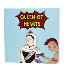 Load image into Gallery viewer, Photo of a light blue card featuring Queen Victoria, seated, wearing a black dress, white headdress, and coronet, along with a sash that reads “Queenz On Tour”. She is receiving a tattoo on her left arm of a red heart with “Albert” across it in a banner. The tattooist has a red Mohican, earrings, and a “YAASSS QUEEN” tattoo. The main caption reads “Queen Of Hearts” in yellow text in a dark red exploding bubble.