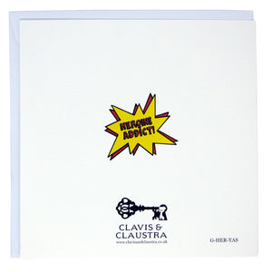 Back of the card. Mostly white, with the Clavis & Claustra key logo and “HEROINE ADDICT!” logo in red text on a yellow exploding bubble.