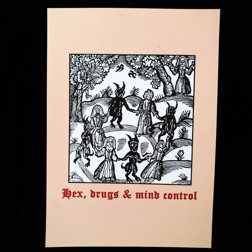 Photo of a print featuring a black-and-white mediaeval woodcut artwork on a taupe background, depicting witches and demons joining hands and dancing in a circle. Beneath it the caption reads 'Hex, drugs & mind control' in a red Gothic typeface.