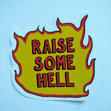 Load image into Gallery viewer, Photo of a sticker shaped like a fire with “Raise Some Hell” in red as the text.