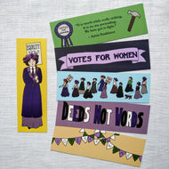 Photo of six bookmarks, all suffragette themed and with individual designs. The most prominent is yellow and shows the full profile of a suffragette in dark blue clothing who holds a sign on her shoulder that says “Equality Now!”. The others show bunting that spells “Votes For Women”, “Deeds Not Words” in different colours, a parade of suffragettes, “Votes For Women” on a purple banner, and a Sylvia Pankhurst quote bracketed by a toffee hammer and “Votes For Women” rosette.