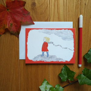 The card in red: a girl in blue boots and a red coat and grey scarf standing on the moors, as the wind blows through her blonde hair. Behind her is the caption “No coward soul is mine - Emily Bronte”. Next to the cards are some autumn leaves and a felt tip pen.