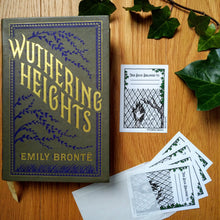 Load image into Gallery viewer, Photo of a single bookplate next to a hardcover edition of Wuthering Heights. The bookplate shows an illustrated ghostly hand smashing through a window next to a gnarled dead tree. On the panes are written: “Let me in! Let me in!”. The borders of the plate say “Wuthering Heights” and “Emily Brontë” and there is a space at the top that says “This Book Belongs To” with two dotted lines to fill in the name, all framed by ivy. Next to this is an opened pack of the bookplates, spilling out.