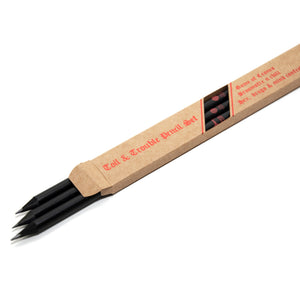 Set of three graphite pencils painted black with black wood, featuring slogans "Game of Crones", "Broomstix n chill" and "Hex, drugs & mind control". They are presented in a kraft brown box with red foiled lettering, their nibs peeping out.