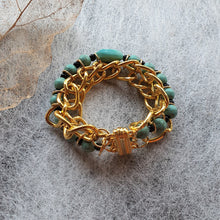 Load image into Gallery viewer, Photo of the bracelet, consisting of golden links that interweave with turquouise beads. The bracelet is clasped in a circle.
