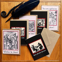 Load image into Gallery viewer, Photo of a the “Witches’ Coven” card pack with all six laid out next to each other, showing the “Best Fiends Forever” card alongside “Witches Be Blazin’”, “Party like its 1599”, “Haters Gonna Hate”, “Hex Addict”, and “Witch, Please!”. Along with the brown envelope, also pictured are a black quill and a letter opening with a curled end.